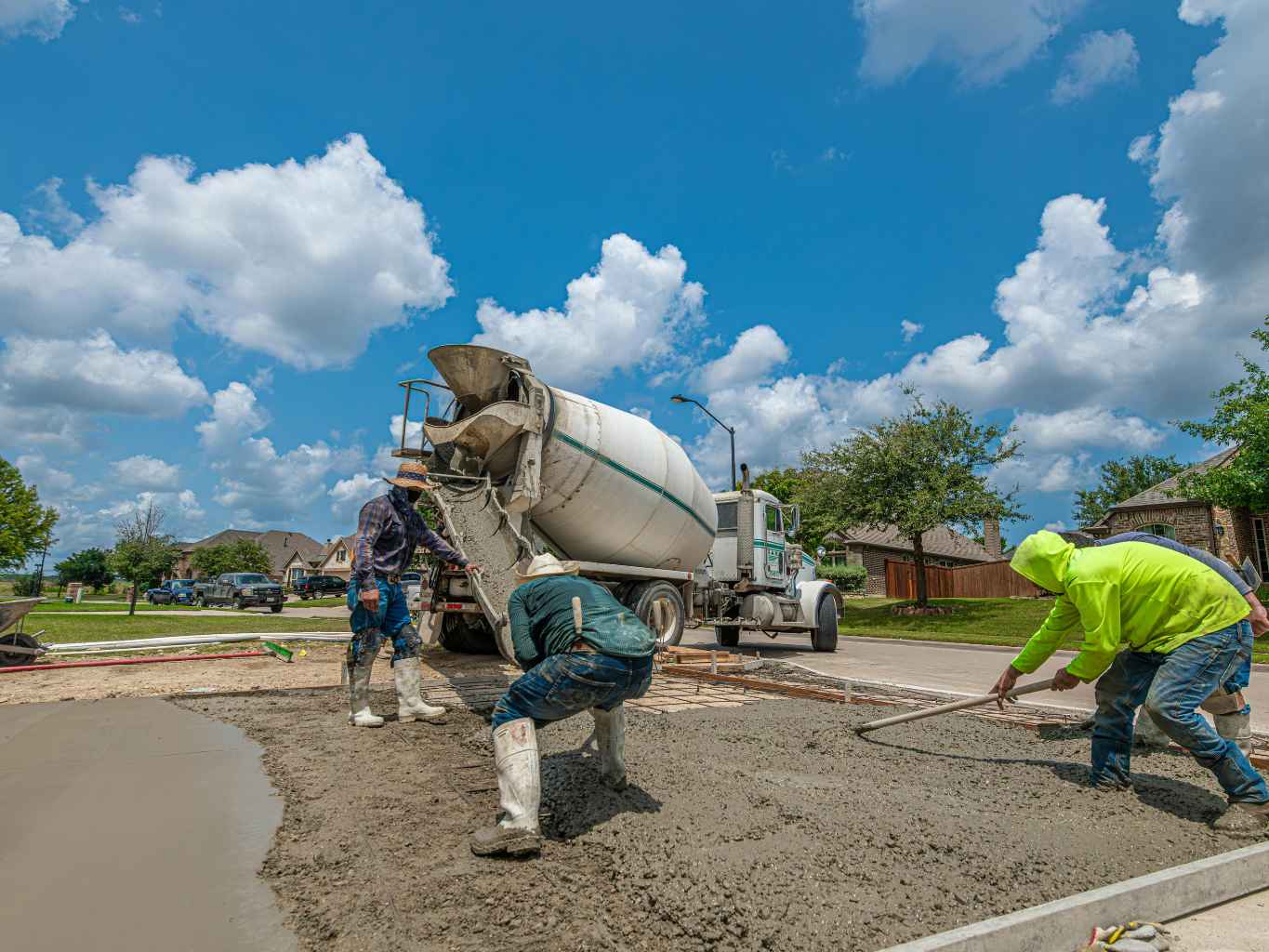 a concrete crew in action performing laser-leveled pours and clean edge tooling